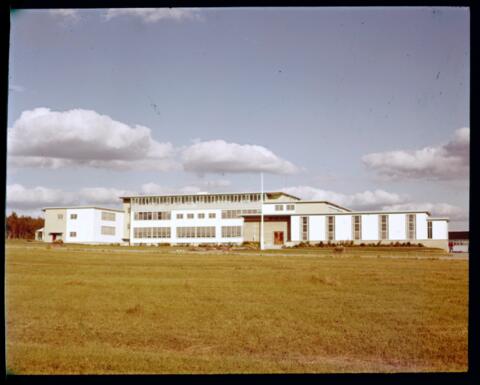 A white building in a grass area