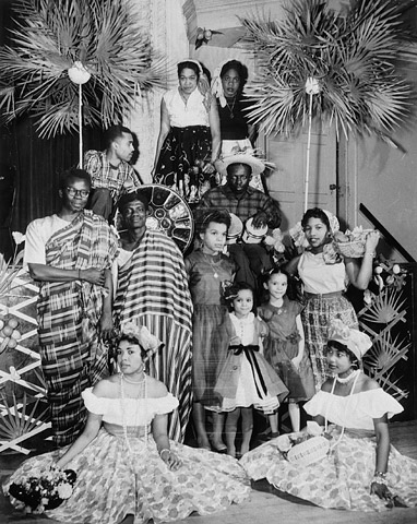 Black and white photo of a group of people inside