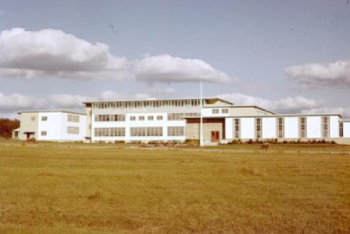 A white building in a grass area