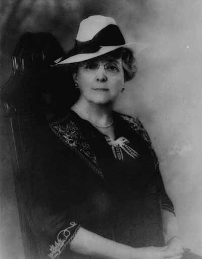 Black and white portrait of a person wearing a hat