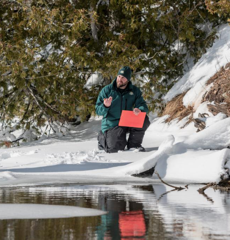 Cover: Resource conservation staff monitoring otter tracks and activity on the snowy and frozen Kouchibouguac River, Kouchibouguac National Park, 2020