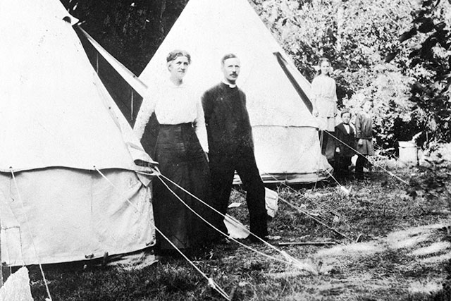 A couple standing in front of a military bell tent, circa 1914. 