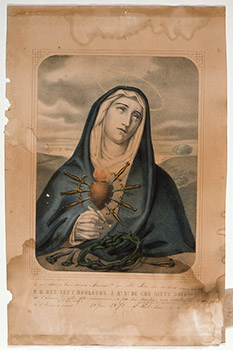 Lithograph depicting the Virgin Mary with her hands clasped in front of her. She wears a blue robe and her heart is superimposed in the foreground with seven daggers protruding from it. Lithograph prior to conservation work; shows some staining due to water and light damage. 