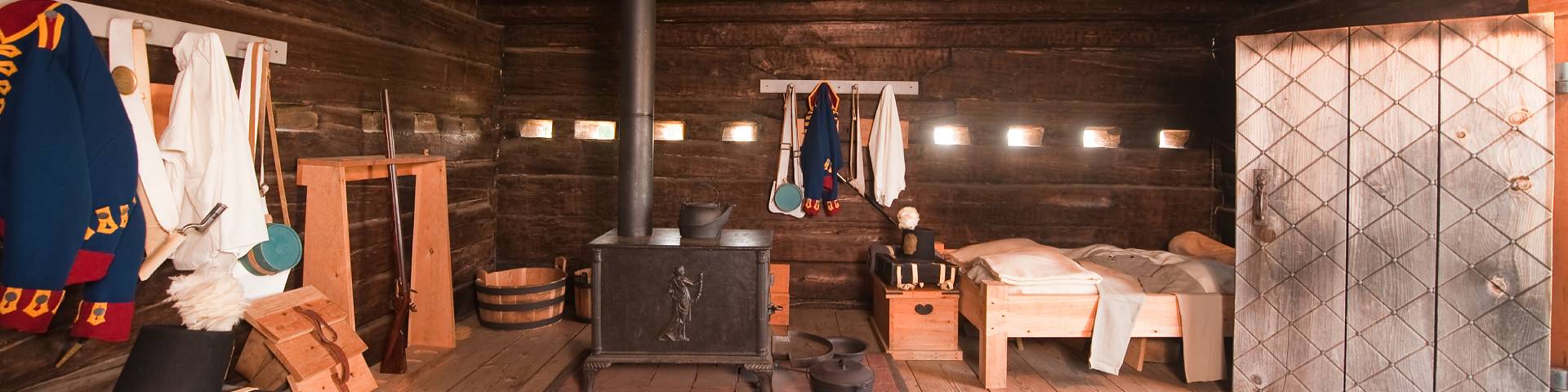 A room filled with old military clothes and equipment