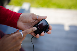 close-up of a hand holding an audio device