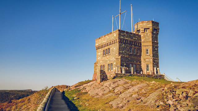 a stone tower next to a paved path