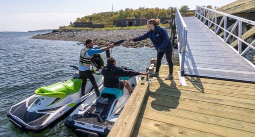 Visitors disembarking at the floating dock; the gangway is in the background. 