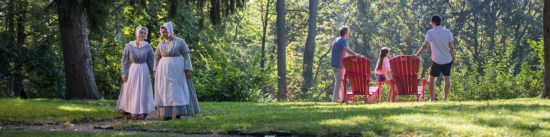 Costumed staff walk in the gardens.