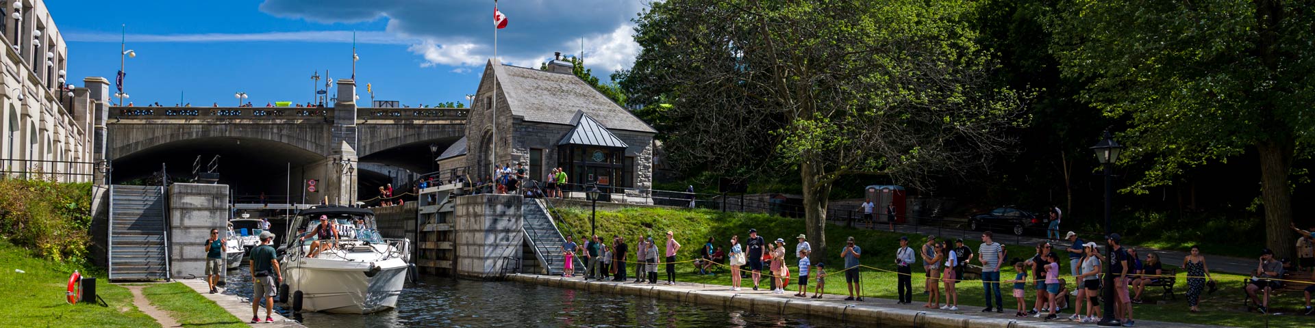 Visitors watching a boat lock through in downtown Ottawa