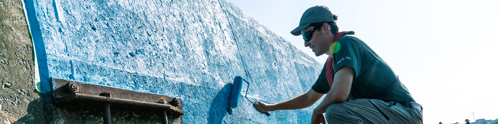 A staff member painting a wall.