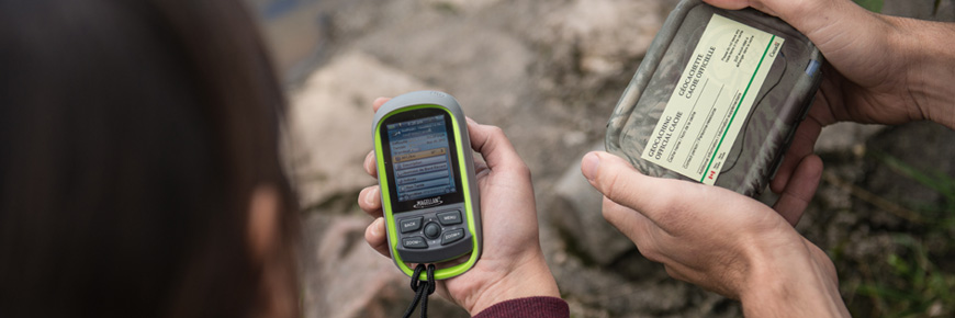 Two people holding GPS units.