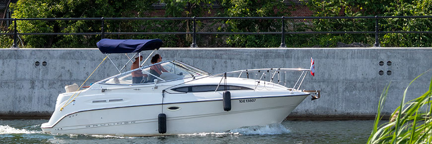 Couple driving a boat on the Lachine Canal.