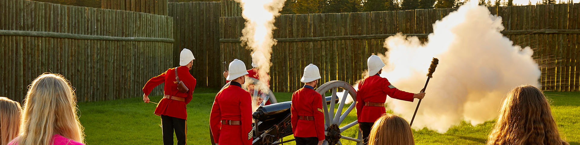 Des visiteurs assistent à une démonstration de tir de canon au lieu historique national du Fort-Walsh.