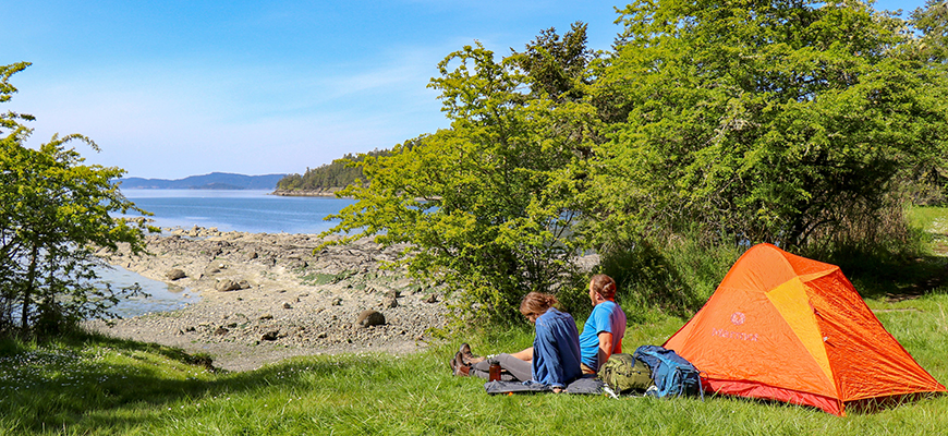 A couple relaxes near their tent