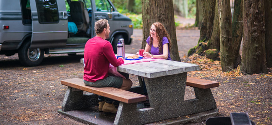 A couple relaxes near their tent