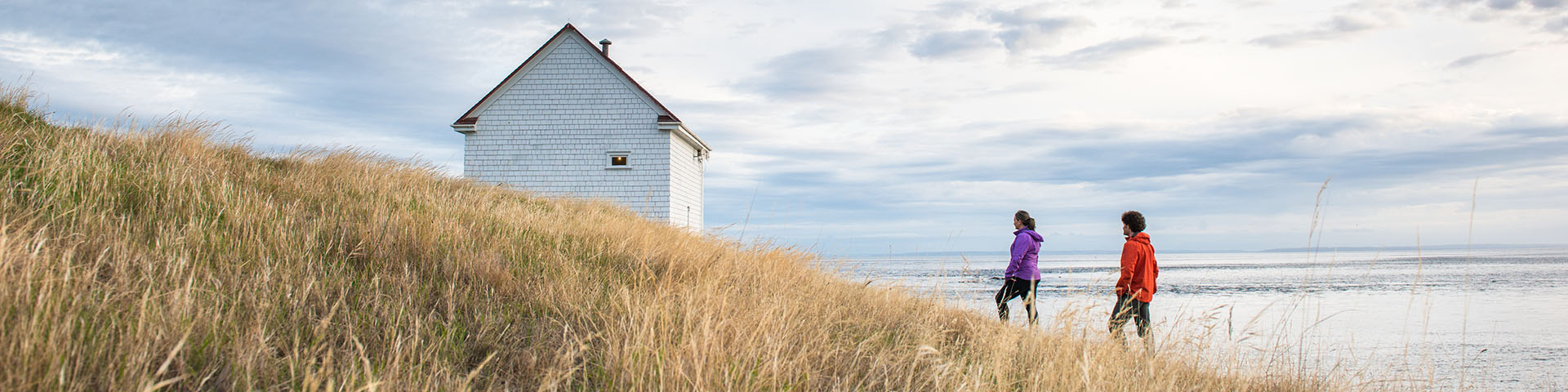 Two visitors head to the historic museum building at East Point on Saturna Island.