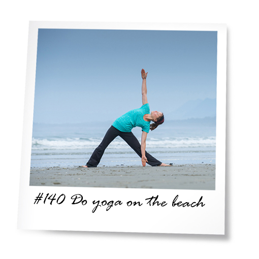 Woman on beach doing yoga