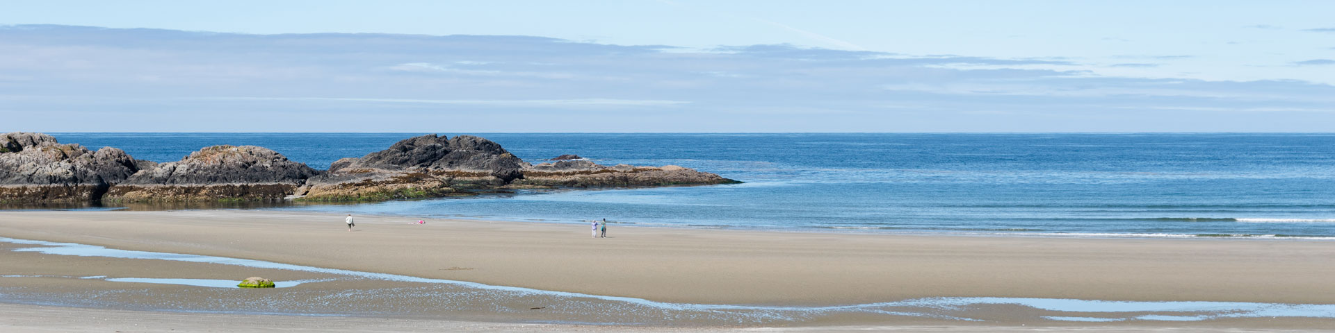 Beautiful beach landscape with people walking in the distance