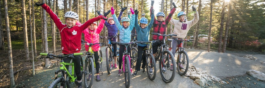 Kids riding bikes at the Pump Track in the Chignecto Receation Area of Fundy National Park