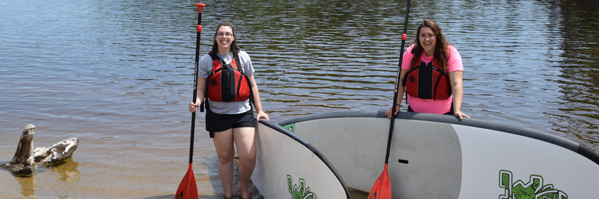 Two people with stand up paddleboards