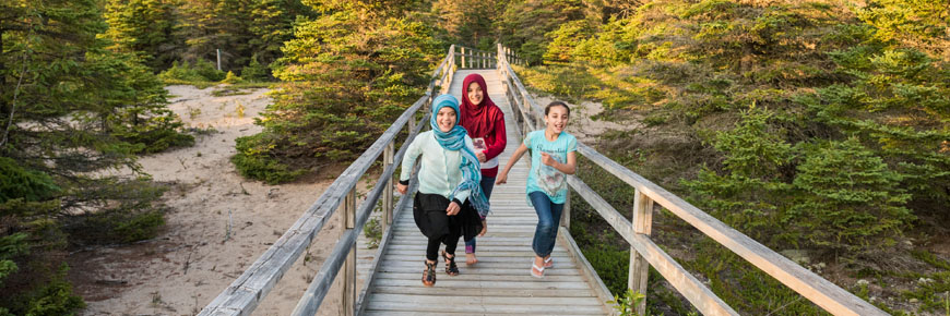 Three children on a boardwalk