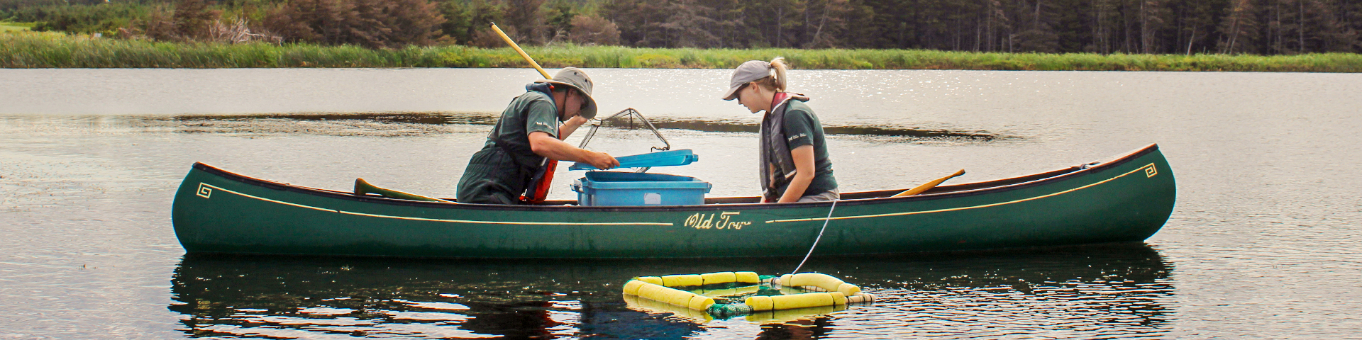 Two parkies in a canoe on a lake