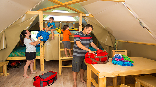 A family unpacks as they settle in to their oTENTik