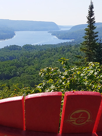 The top of a red chair's back with Lake Rosoy in the background