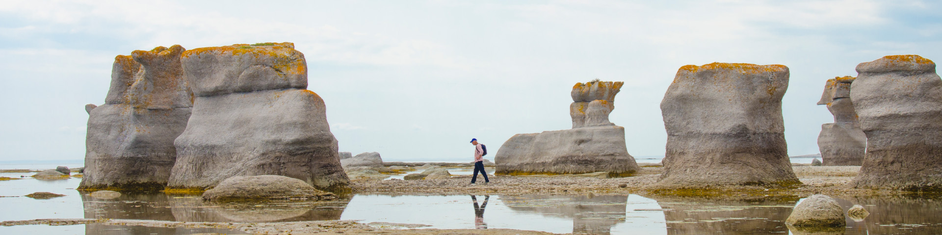 A man walks by the monoliths