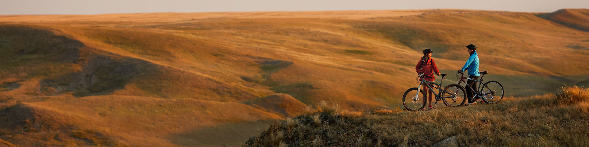 Two people mountain biking in the hills. 