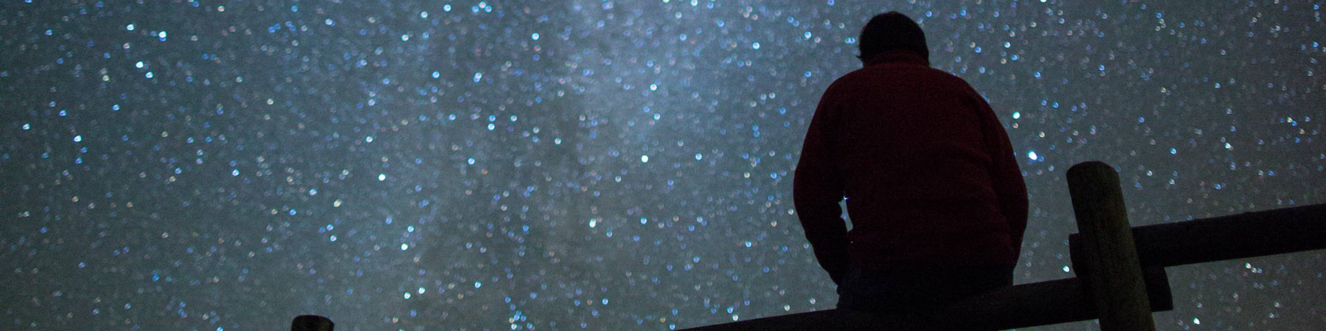 Visitor enjoying the breathtaking views of the Milky Way at night from the Frenchman Valley Campground in the Dark Sky Preserve, in Grasslands National Park.