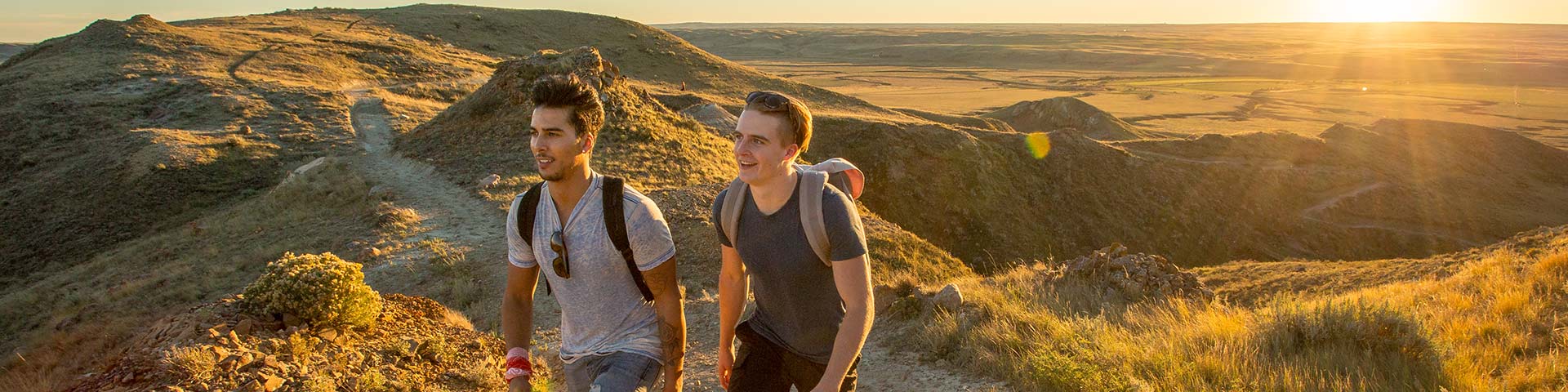 Young adults out hiking on the 70 Mile Butte Trail at West Block, in Grasslands National Park