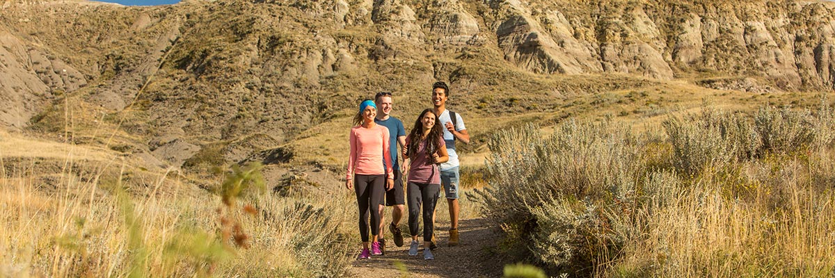 A group of young adults out hiking on the 70 Mile Butte Trail at West Block, in Grasslands National Park.