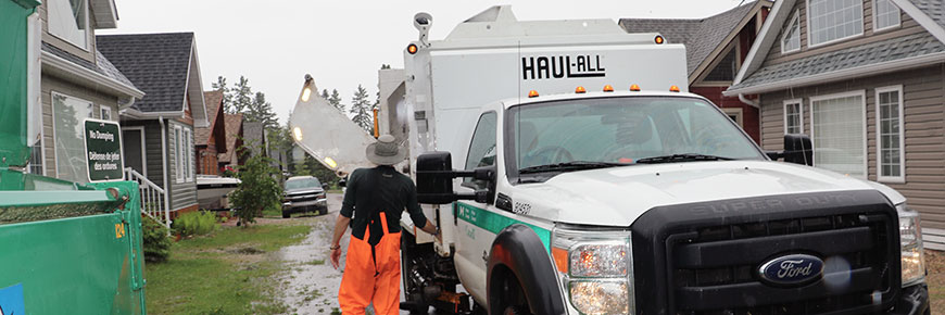 A Parks Canada employee operates the recycling truck. 