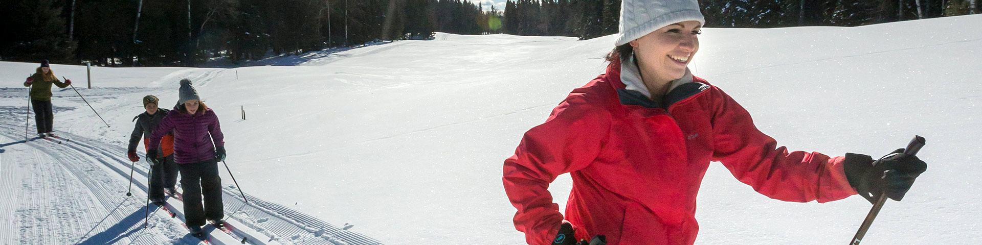 A family cross-country skis on the Wapiti Trail. Prince Albert National Park