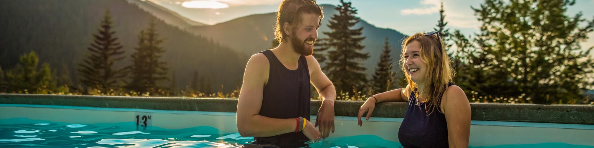 A couple enjoying their time in the Miette Hot Springs wearing the heritage swimsuit